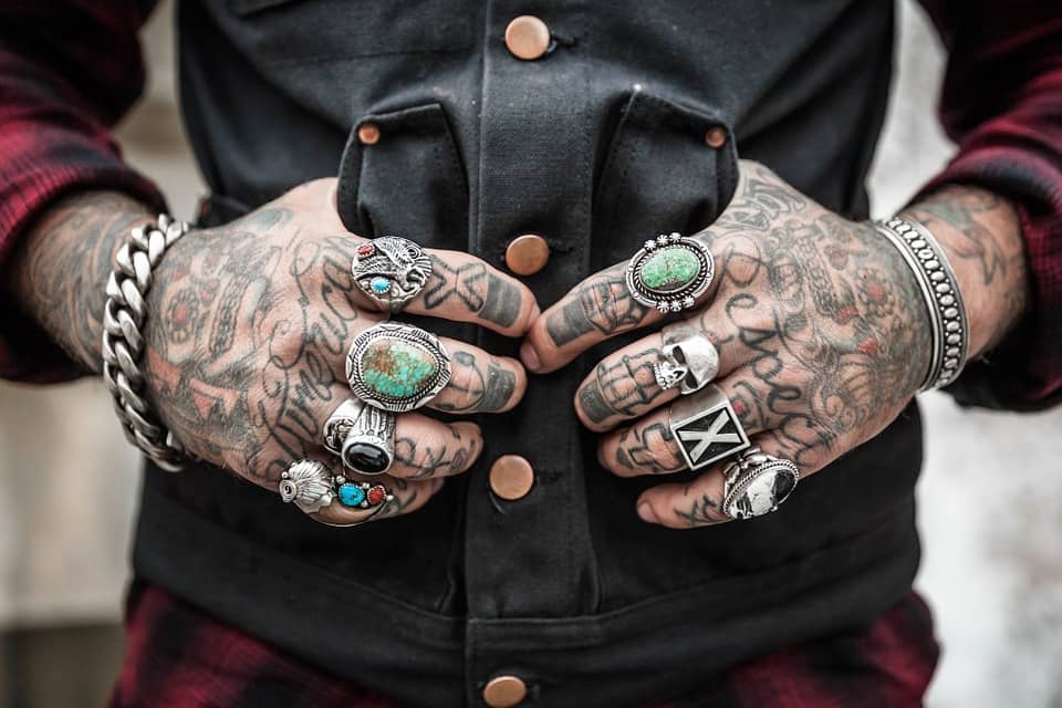 A mans hand full of tattoo